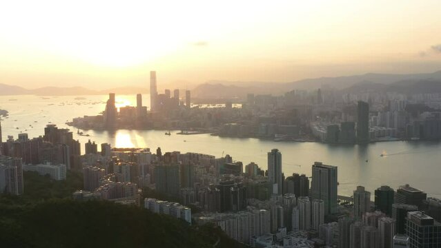 Aerial View Sunrise of the Hong Kong City Skyline and sunflares 4K stock video. 