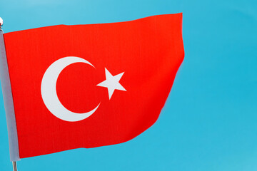 Turkish flag waving on blue background