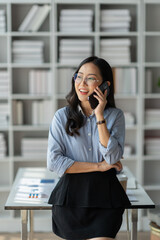 Modern working lifestyle, Asian businesswoman using mobile phone to contact Talking with business...
