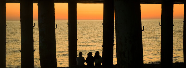 Happy summer group of girlfriend vacation. Silhouette of kids, girls and female having fun together...