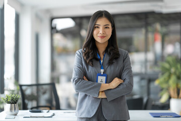 Confident young businesswoman, company employee smiling with arms crossed and happy in her...
