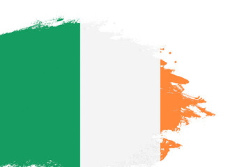 Ireland flag on a stained stroke brush painted isolated white background with copy space