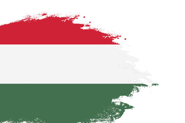 Hungary flag on a stained stroke brush painted isolated white background with copy space