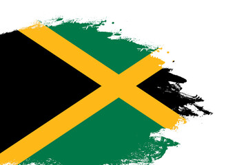 Jamaica flag on a stained stroke brush painted isolated white background with copy space