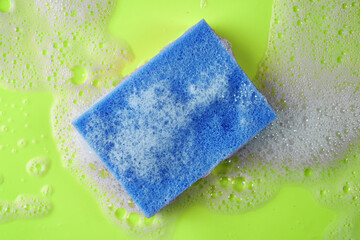 soap foam and sponge on a green background