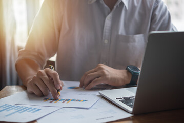 Businessperson report graph analysis marketing and paperwork chart finance investment strategy with laptop computer.