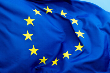 European Union Flag waving on blue background