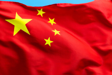 Chinese flag waving on blue background