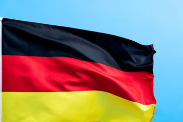 Germany flag waving on blue background