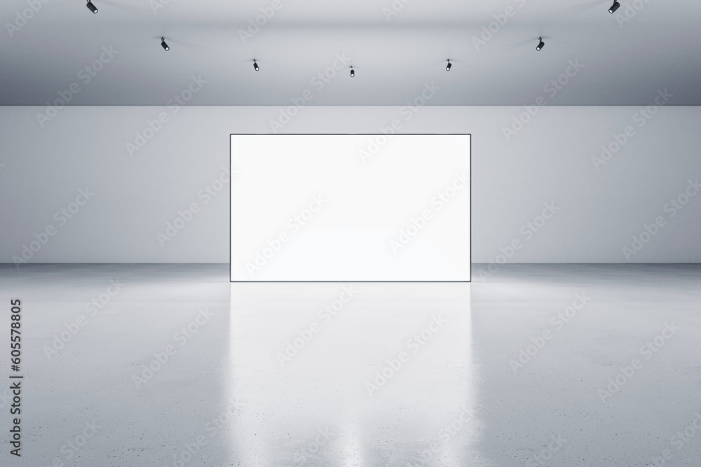 Wall mural front view of blank white glowing digital screen in grey hall interior with concrete floor and light