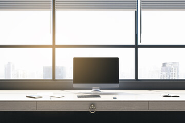 Luxury office interior with panoramic windows and city view, blinds, empty mock up computer screen, furniture and sunlight. 3D Rendering.