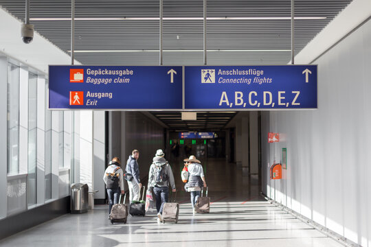 Unrecognizable People With Bags And Suitcase Walking In Airport Terminal. Rear View Of Passengers On Their Way To Flight Boarding Gate, Ready For Business Travel Or Vacation Journey