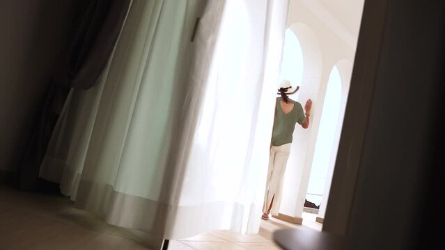 Elegant female tourist checking into luxury Mediterranean hotel 