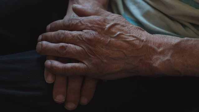 wrinkled hands of an old father, selective focus, veins and wrinkles on the hands of a pensioner. concept old people, senile age.
