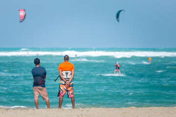 Active sporty people enjoying kitesurfing holidays and activities on perfect sunny day on Cabarete...