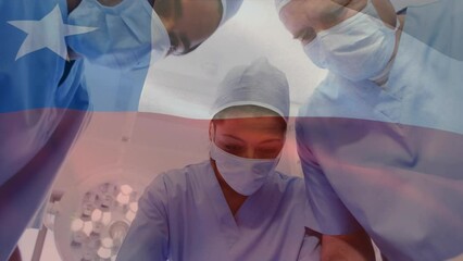 Animation of waving texas flag against team of surgeons performing surgery at hospital - Powered by Adobe