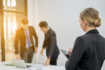 Group of Smiling Businessmen Working on Laptops at Desk in Office With Caucasian Colleagues using Digital Tablet During General Project Meeting