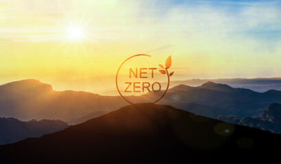 Net Zero sign on top of mountain at sunset, surrounded by eco-friendly nature. net zero refers to...