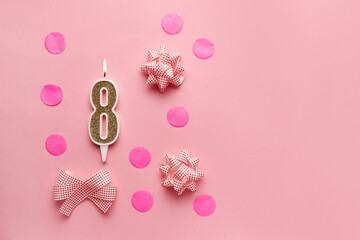 Number 8 on pastel pink background with festive decor. Happy birthday candles. The concept of celebrating a birthday, anniversary, important date, holiday. Copy space. Banner