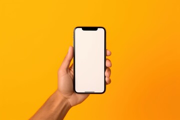 Hand holding smartphone isolated on yellow background. Generative AI
