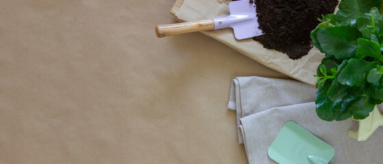 Garden tools, flower pots on table, top view. The concept of gardening at home. Banner.