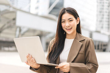 Business freelance asian woman using laptop computer sitting at outdoor
