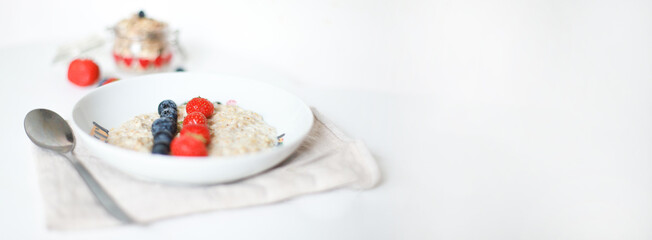 Fototapeta na wymiar Banner Oatmeal with berries. Blueberries, strawberries. Proper breakfast. Carbohydrates