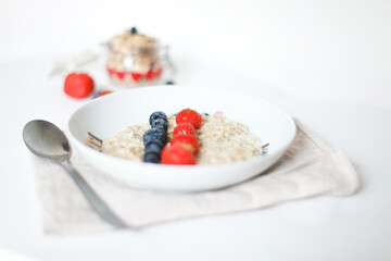 Oatmeal with berries. Blueberries, strawberries. Proper breakfast. Carbohydrates