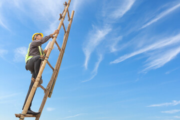 Asian business man engineer climbing up ladder with blue sky, career growth and success concept © Kwangmoozaa