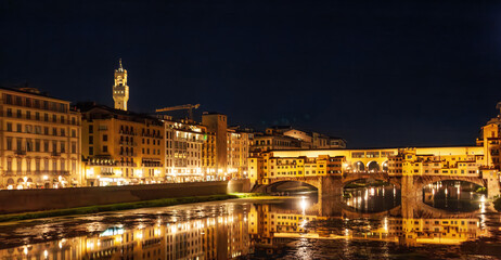 Fototapeta na wymiar River Arno and famous bridge Ponte Vecchio at night from Ponte Santa Trinita in Florence, Tuscany, Italy