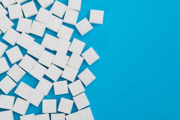 Sugar cubes on blue background