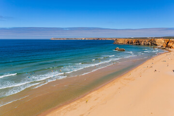 View of surfers on sandy beach