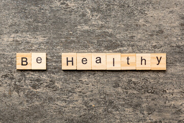 be healthy word written on wood block. be healthy text on table, concept