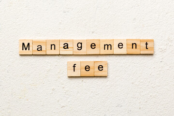 management fee word written on wood block. management fee text on cement table for your desing, concept