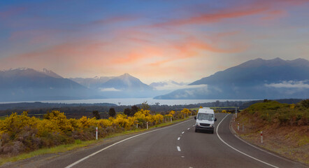 The Road trip view of  travel with mountain view of autumn scene and  foggy in the morning with sunrise sky scene at fiordland national park
