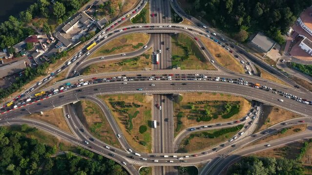 Multi motorway roads with traffic jam and moderate car traffic. Aerial top view. Fast speed motion.