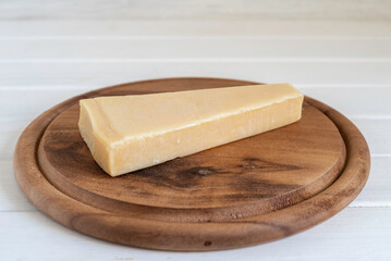 Parmesan cheese for Jewish holiday Shavuot on wooden background.