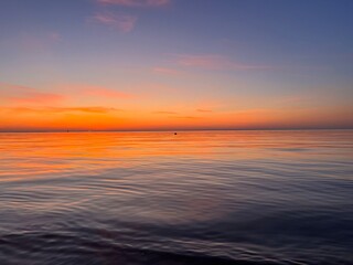 Fototapeta na wymiar Seascape after the sunset, orange sunset sea horizon, twilights sea view background