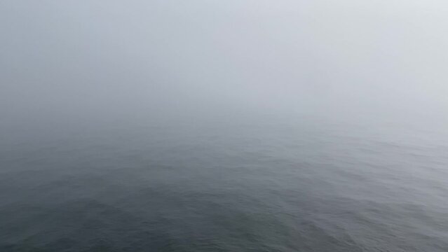 a sea and waves in foggy weather