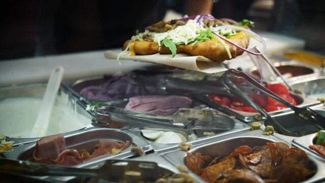 Restaurant Chef Topping Hungarian Fried Langos With Sliced Red Onion. closeup