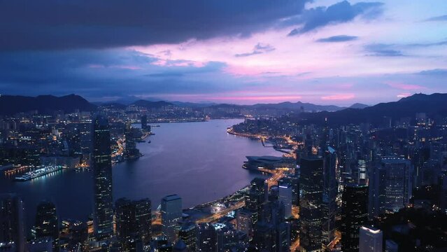 Aerial view from flying drone of Central of Hong Kong at night time. modern skyscrapers and tall edifices of megapolis.