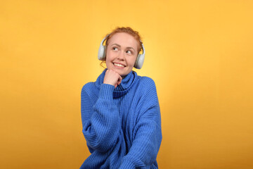 cute happy woman enjoying music in headphones