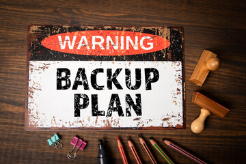Backup Plan. Warning sign with text on wooden office desk