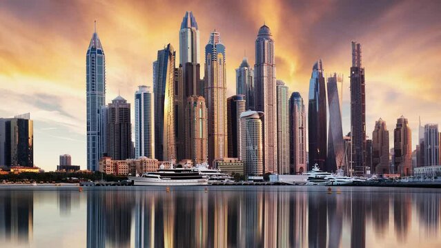 Dubai Marina with skyline time lapse - luxury and famous Jumeirah beach frontline at sunrise, United Arab Emirates