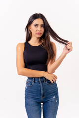 Brunette woman on a white background, casting studio photos, portrait in jeans and black t-shirt