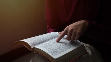 Christian teenager reading bible or book, Sunday readings bible. Concept for faith, spirituality...