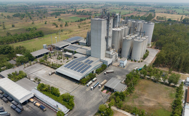 Aerial view of animal feed factory. Agricultural silos, grain storage silos, and solar panel on...