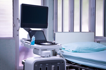 Medical equipment and a room with a patient bed. Inside an empty hospital room