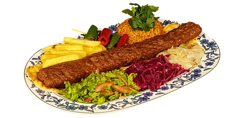 isolated turkish flavor adana, urfa kebab served with onion, tomato, pepper and bulgur pilaf on a...