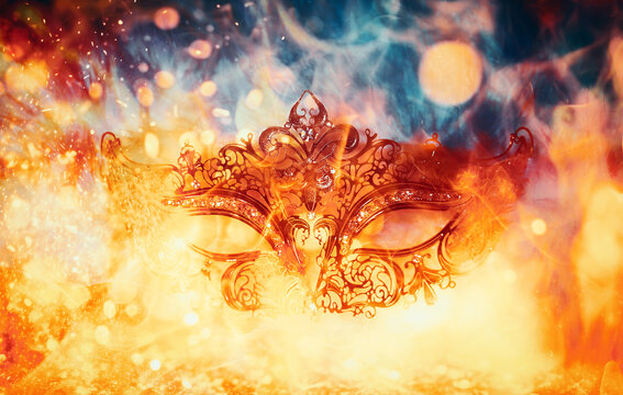 beautiful decorative Venice style mask with filigree linear ornaments, fire background
